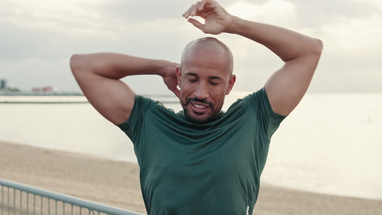 Fit Man Stretching His Arms on the Beach