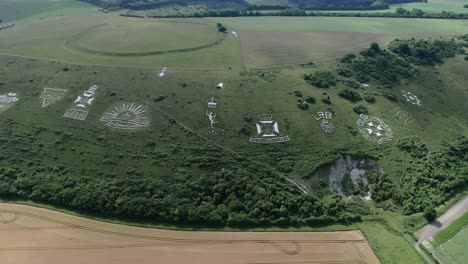 fovant set of regimental badges carved into chalk hillside aerial view panning across the wiltshire countryside