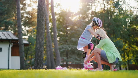 mom helps my daughter to wear roller skates happy time together 4k slow motion video