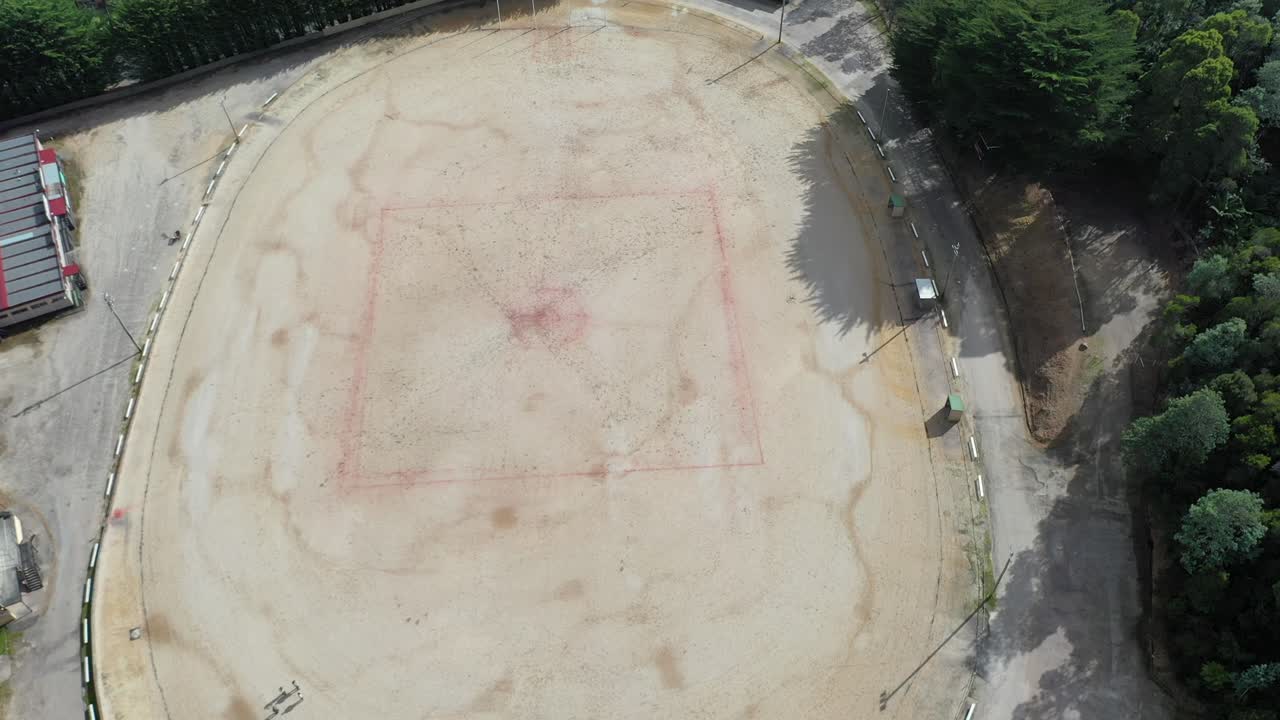 Wide perspective showing whole ground on sunny day - aerial drone shot Queenstown Oval, Tasmania, Australia - famous gravel oval