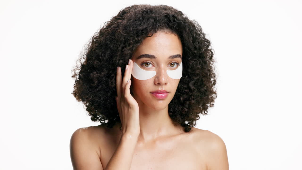 Woman applying eye patches for skincare