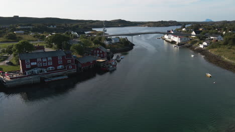 coastal village and road bridge connecting islands in herøy, norway - aerial drone shot