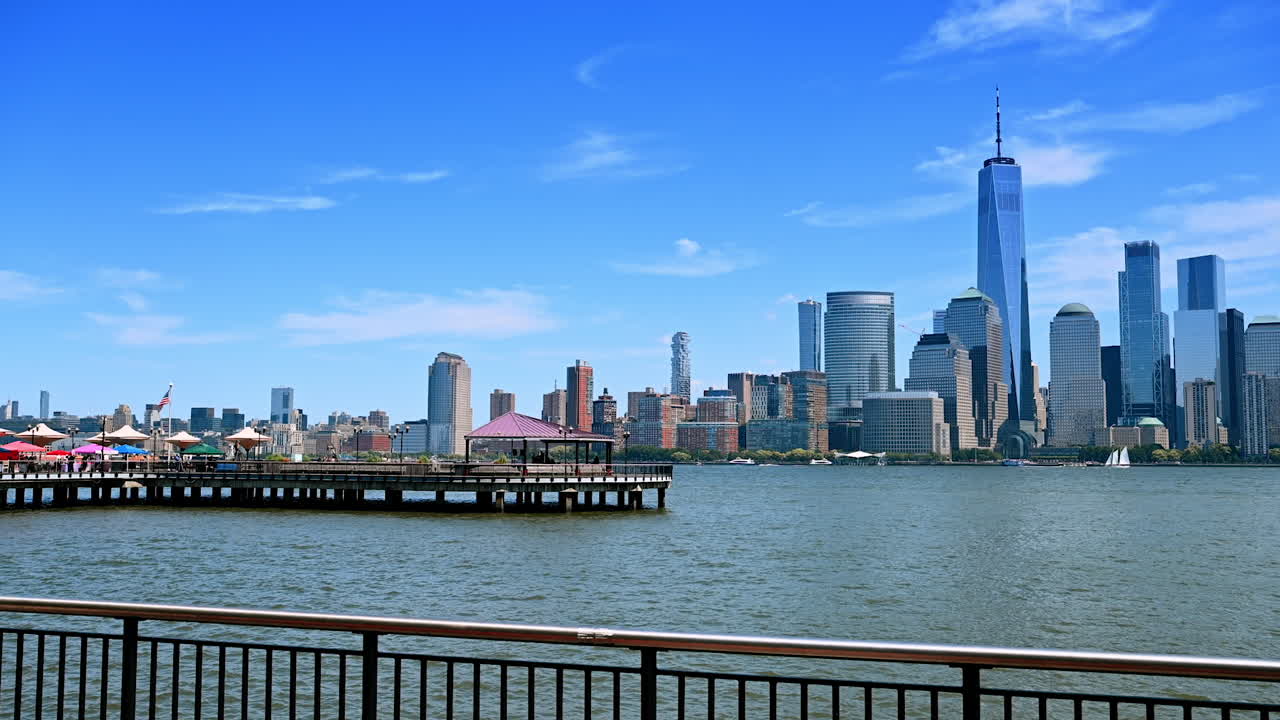 Coming closer to the railing at the pier in Jersey. Enjoying view of Manhattan over the Hudson River on sunny day