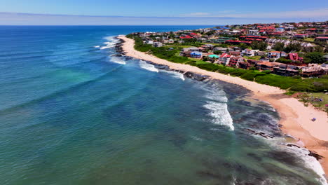 south africa jbay jeffreys bay aerial drone town home buildings most stunning white sand beach epic surf wave aqua blue rugged reef coastline daytime wsl corona open supers boneyard summer forward