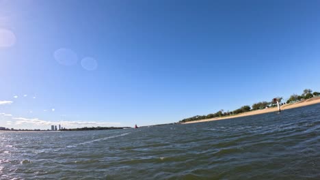 Waves and skyline under clear blue sky