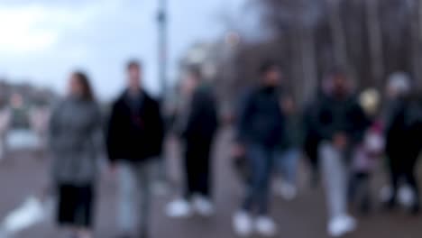 blurred people walking in the street