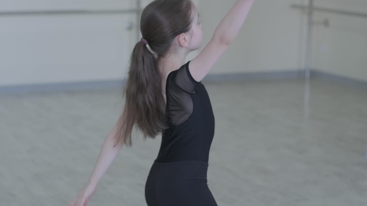 Young ballet girl at studio lesson. Training performance. Stretching exercise pose. Ballerina practice balance technique. Classical elegance fitness.