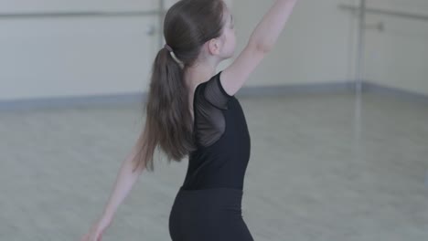 young ballet girl at studio lesson. training performance. stretching exercise pose. ballerina practice balance technique. classical elegance fitness.