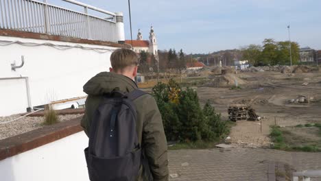 the teenager with drink walks downstairs to the construction site to hide from everyone