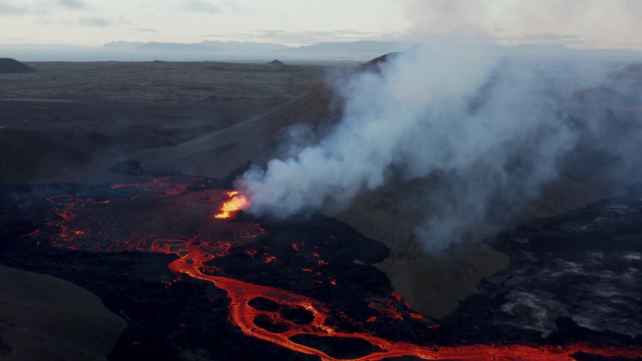 Scenic view of new volcano eruption in Meradalir valley Iceland, Stóri Hrútur mountain, smoke rising