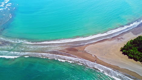 Aerial-drone-4K-footage-revealing-a-beach-shaped-like-a-whale's-tail-in-Ballena-Marine-National-Park,-Costa-Rica