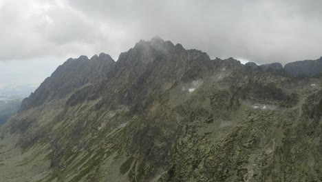 mountain range with amazing cloudy sky in the background near skok waterfall and hrubý vrch in the high tatras mountains in slovakia - aerial shot