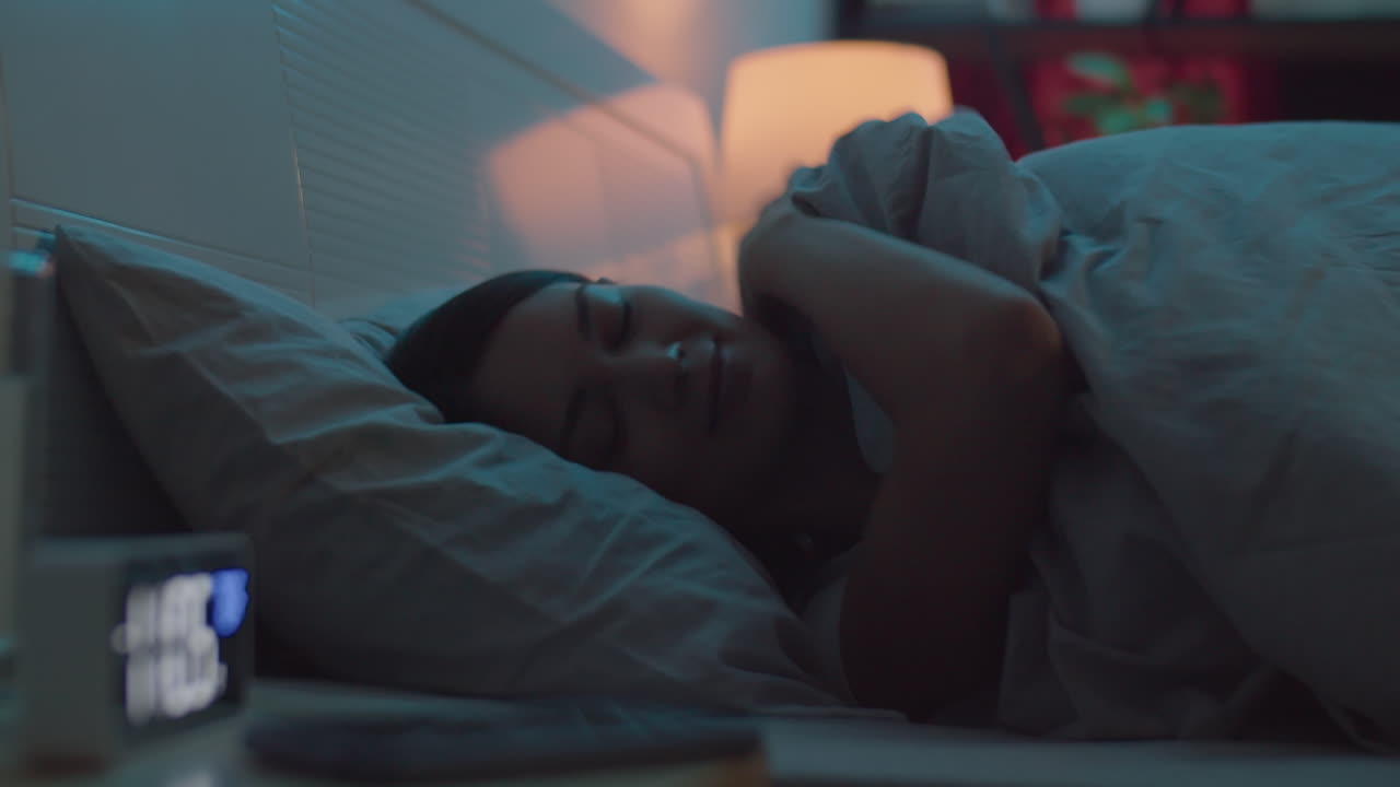 Woman Using Phone and Going to Sleep in Bed