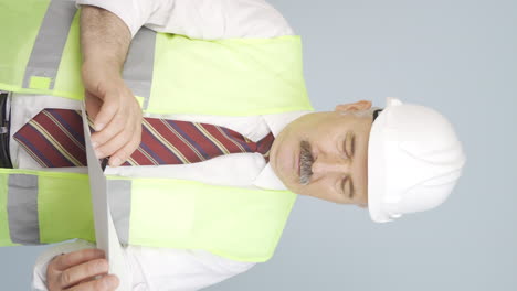 vertical video of the old engineer watching the construction is thoughtful.