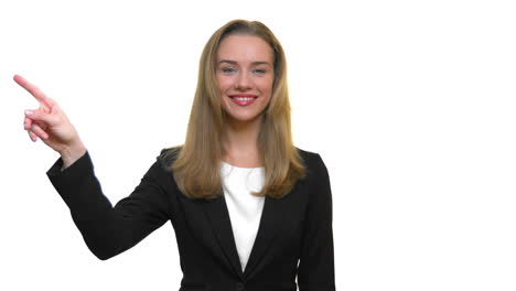 a close-up of a woman smiling and pointing off to the side, then lowering her arm back down to her side, on a seamless white studio background