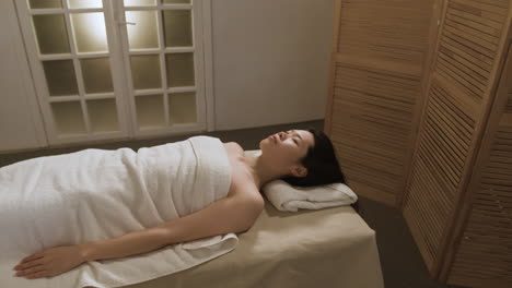woman relaxing on a massage table in a spa
