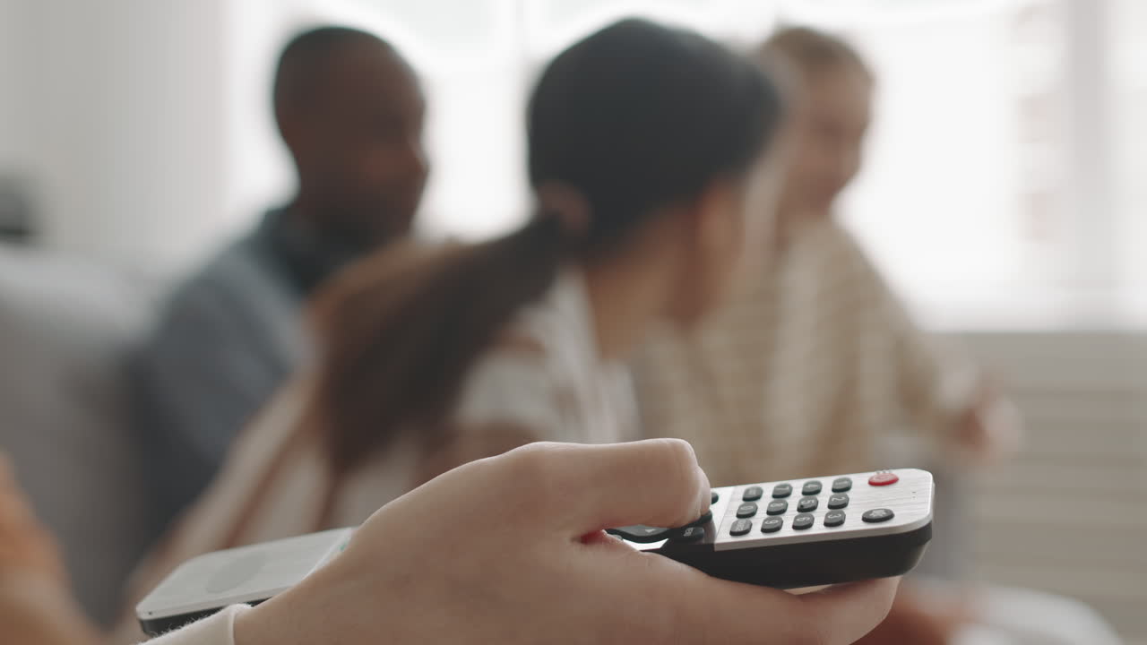 Hand Pushing Button on TV Controller