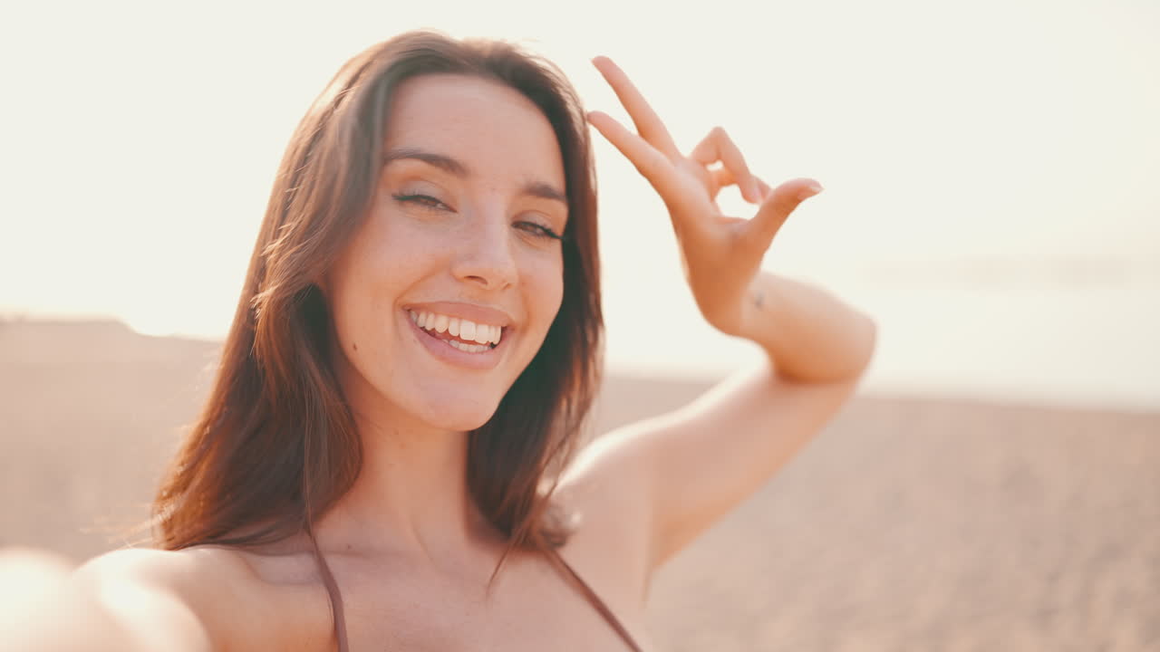 Woman taking a selfie at the beach