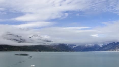 low clouds on top of the mountains in glacier bay national park, alaska