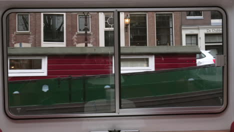 reflections of amsterdam from a window