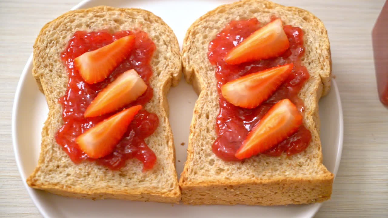 homemade whole wheat bread with strawberry jam and fresh strawberry