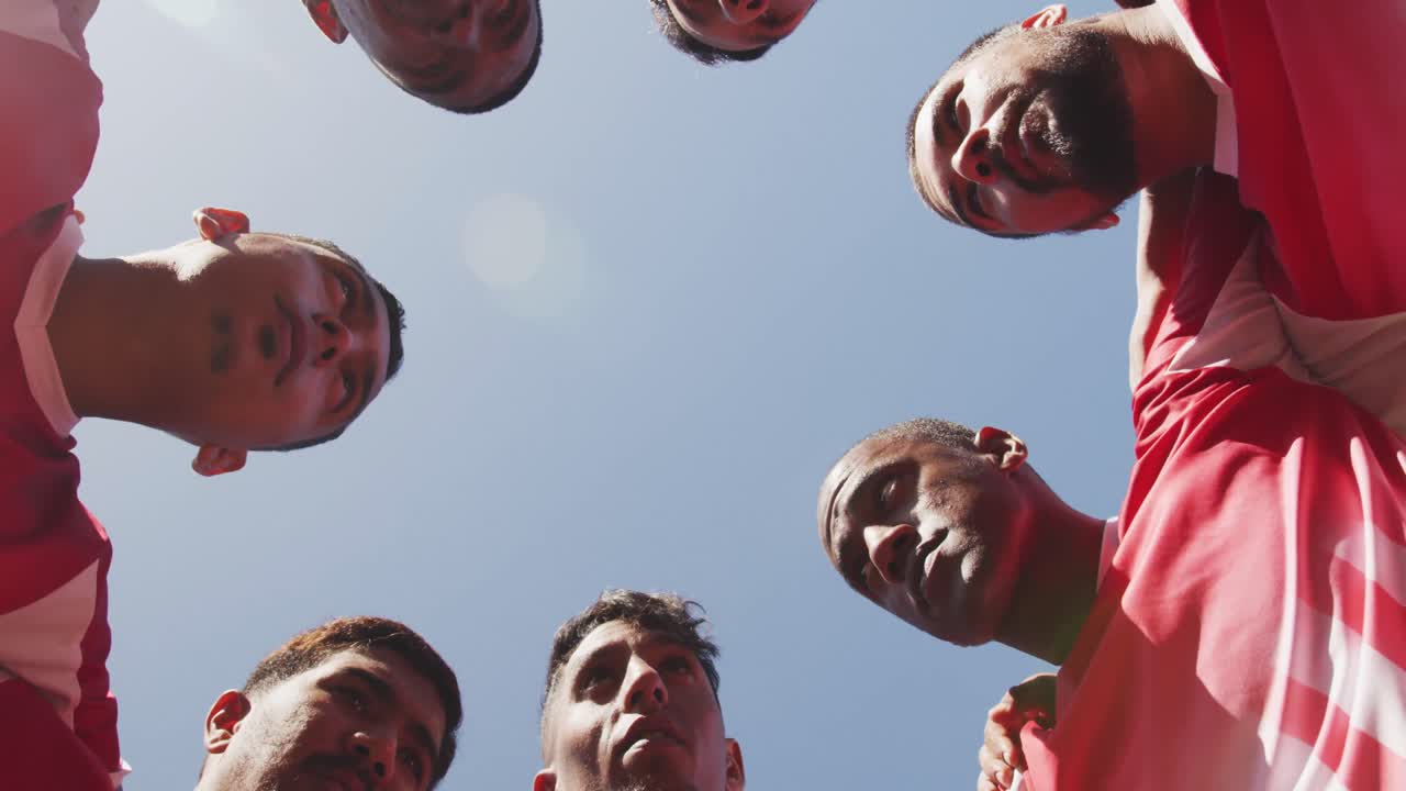 Soccer players motivating on field