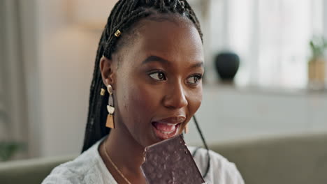 Home,-eating-and-black-woman-on-sofa