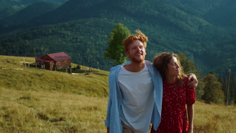 Happy-couple-look-mountains-landscape-view.-Relaxed-lovers-spend-time-on-walk.