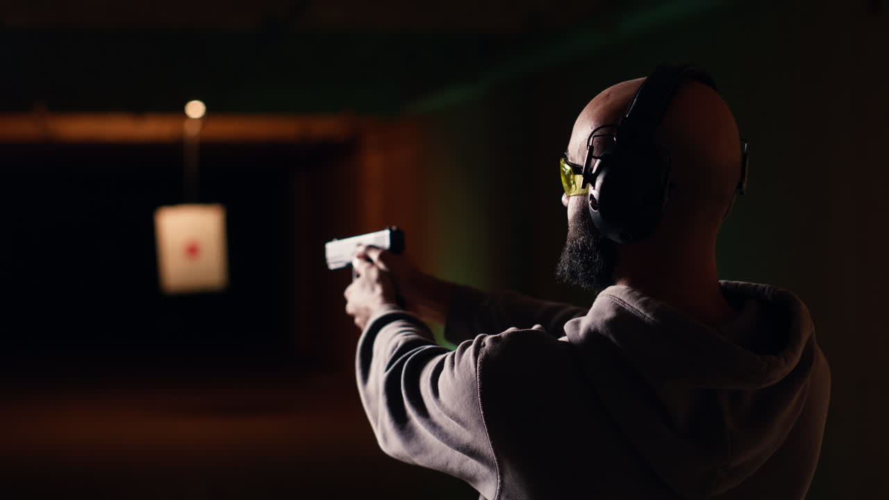 cliente de la galería de tiro usando pistola para golpear objetivos