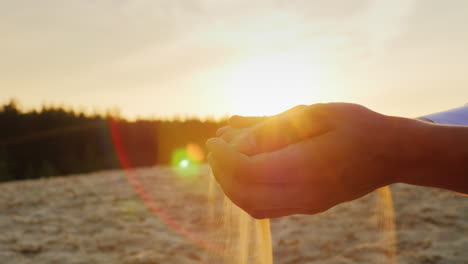 Sands-slip-through-the-hands-of-man-in-a-suit