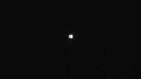 blinking streetlight in the night