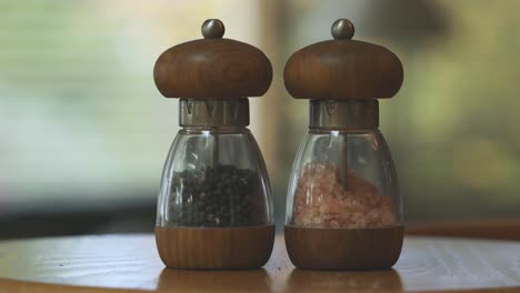 black pepper and pink himalayan salt in spice jars