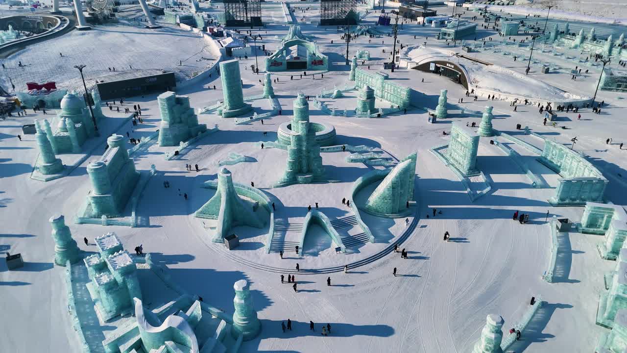 Aerial view of the Harbin Ice Festival 2025, showcasing intricate ice sculptures and towering ice-block buildings. Winter Wonderland blends art, architecture, and creativity in frozen form. China