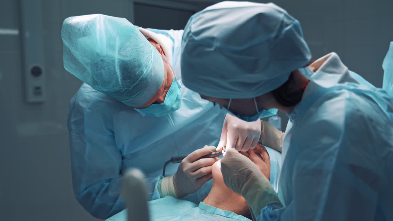 Doctor and assistent during operation. Dentist and a nurse treating a patient teeth