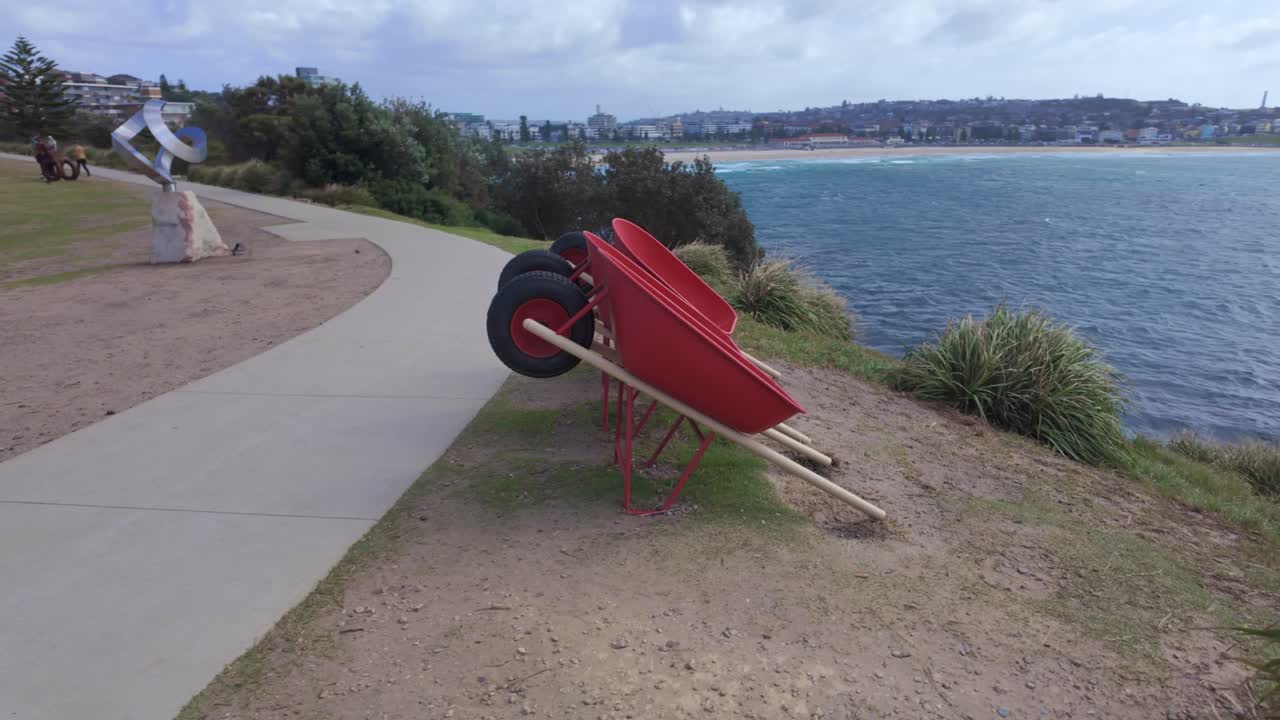 Smoko Seat Scuplture by the Sea at Bondi Beach, Sydney NSW, Australia. panning to the right revealing shot.