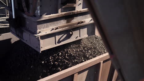 a rapid loading system loads manganese ore into a rail wagon on a mine