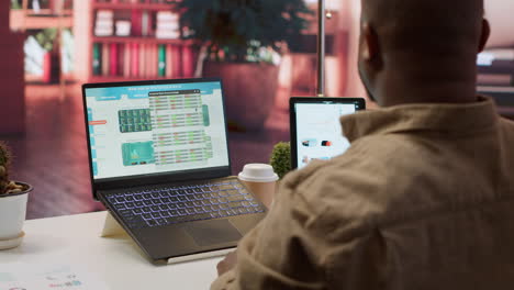 Entrepreneur calculating expenses with online invoices on laptop