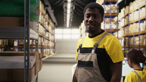 warehouse worker inspecting cargo on racks in a large scale fulfillment center