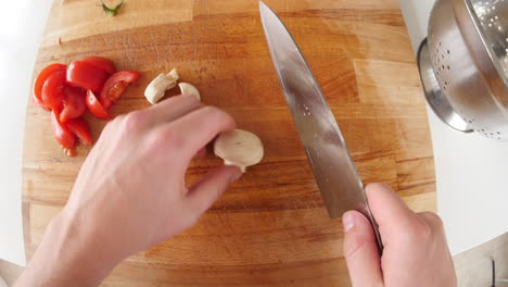 Point-of-view-of-man-chopping-mushroom