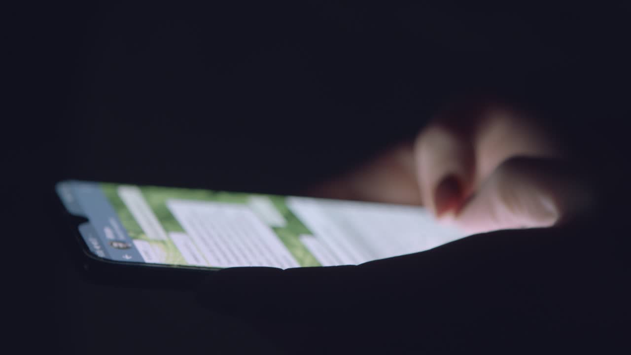 Person using smartphone at night