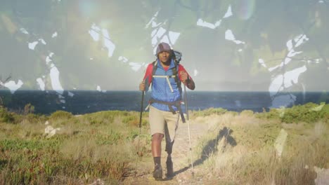 composite video of green leaves on tree against african american man hiking on the mountains