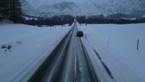 car on a long snowy road