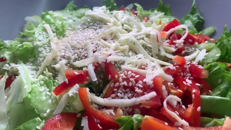 healthy tomato salad with paprika, cheese and sesame on top