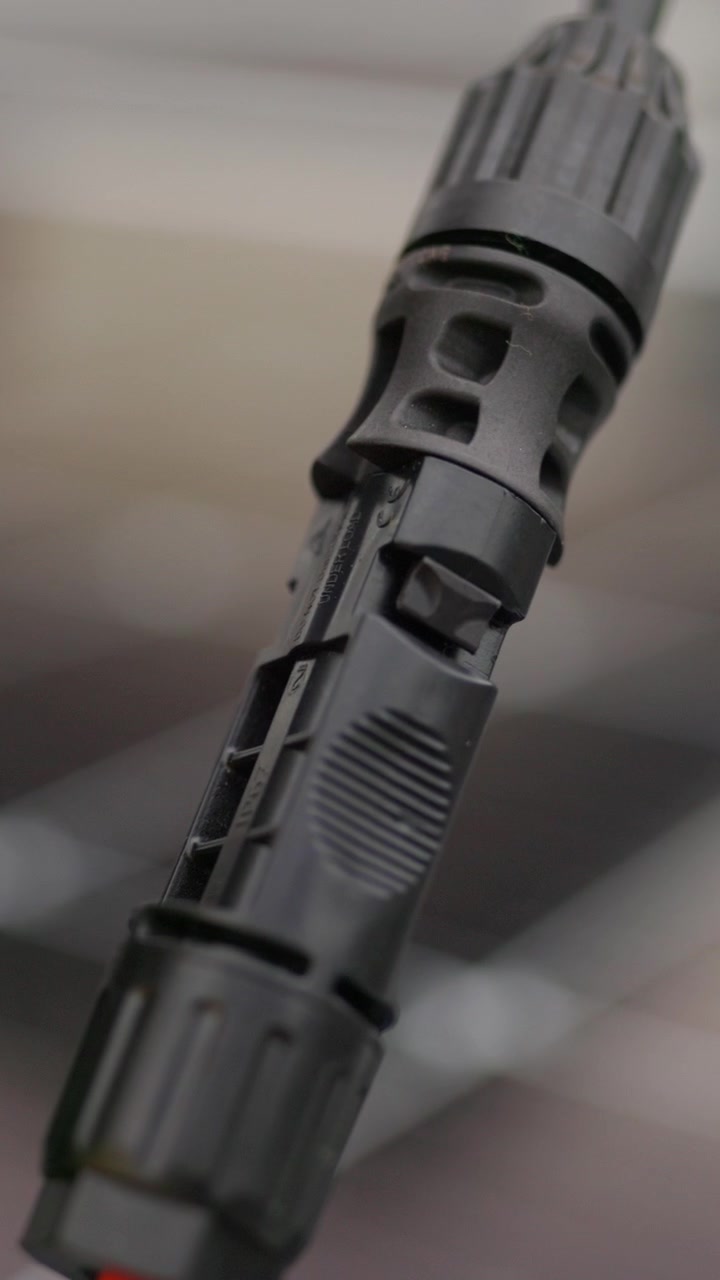 A closeup shot of a solar panel with a tool likely during inspection or maintenance vertical video