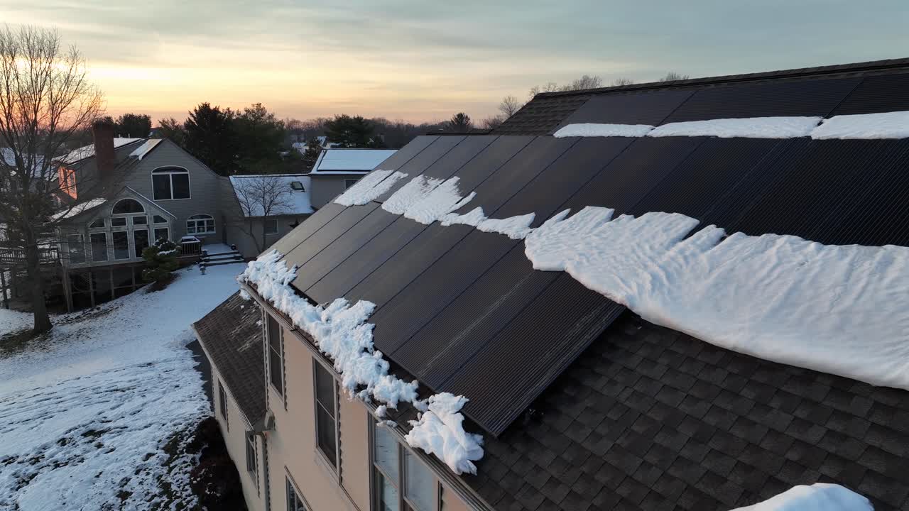 Aerial View of Snow Melting on Solar Panels on a Residential Roof