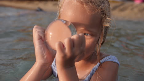 a young girl playing in the water at the beach