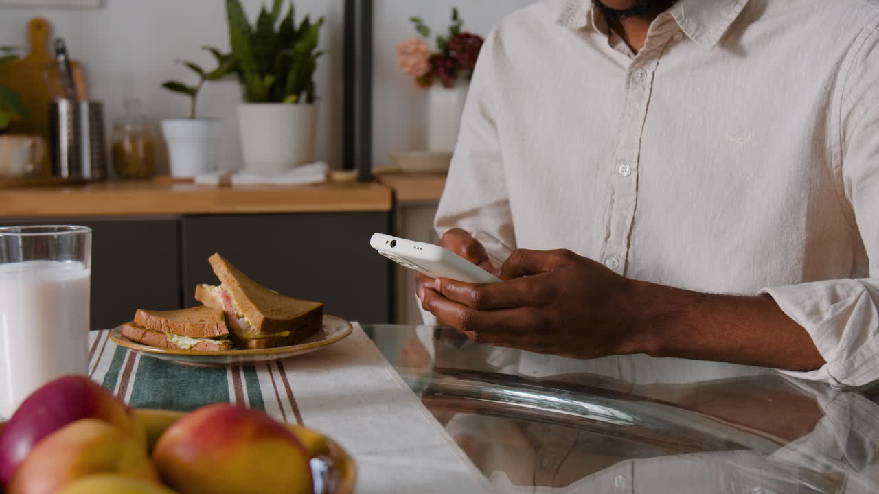 Person using smartphone while having lunch