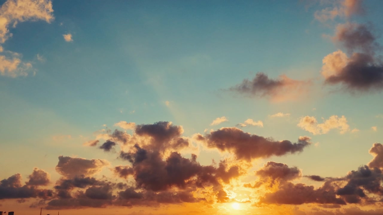 Golden Sunset Clouds Drifting Across a Blue Sky