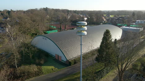 drone flying towards dutch air raid siren on a pole in the netherlands