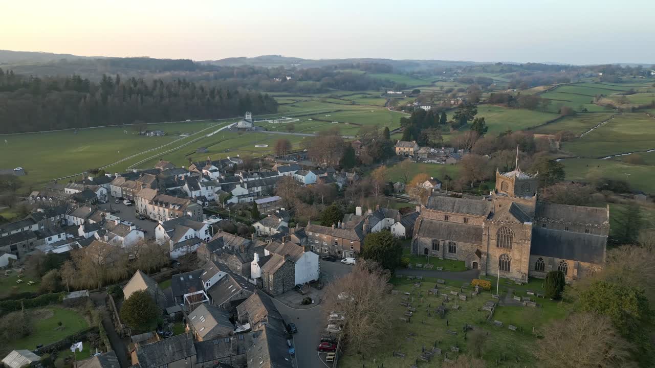 Slow Motion clip of the Cumbrian medieval village of Cartmel showing the historic Cartmel Priory at sunset on a winters day